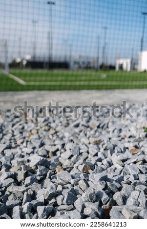 Macro photo of crushed stone. Background of stadium grass football