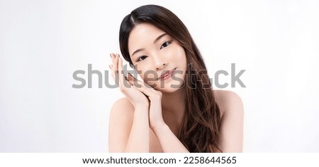 Closeup portrait of beauty asian woman with fair perfect healthy glow skin hand touching cheek isolated on white, young beautiful asia girl with pretty smile on face. Beauty korean spa skincare banner Royalty-Free Stock Photo #2258644565