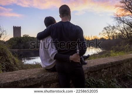 Lover couple. Background sunset lake, starry sky and horizon. Concept date Valentine Day, first kiss love, forever together. Passionate woman gently romantic hug man. Valentine's Day. Models hugging. 