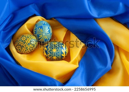 blue and yellow Easter eggs on the background of the flag of Ukraine Royalty-Free Stock Photo #2258656995