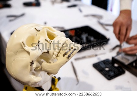Skull models being used to train surgical residents to treat jaw fractures Royalty-Free Stock Photo #2258662653