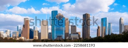 Houston Texas downtown buildings and city skyline, panoramic metropolis landscape with dramatic clouds over the public park