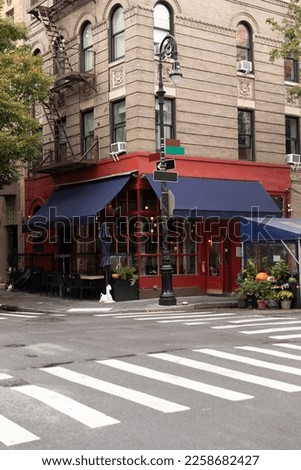 Cafe on corner of modern building on street in New York City Royalty-Free Stock Photo #2258682427