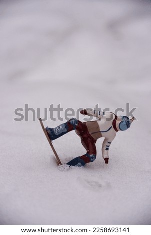 a figure of a snowboarder in the snow.