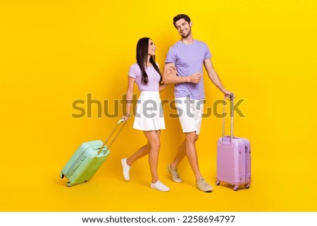 Full body photo of cute young girl male hug arms baggage summer vacation dressed stylish violet clothes isolated on yellow color background