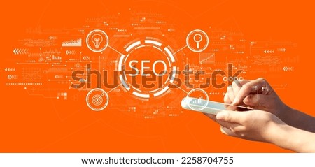 SEO concept with person using a smartphone on a orange background