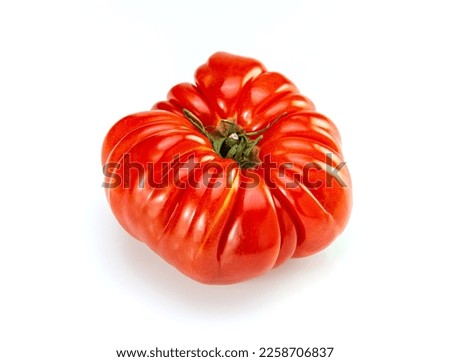 Isolated heirloom tomatoe on white table for cooking Royalty-Free Stock Photo #2258706837