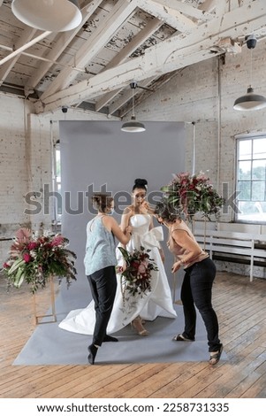 Beautiful mixed race bride in white tailored designer gown and tropical floral arrangements with anthurium and peony flowers