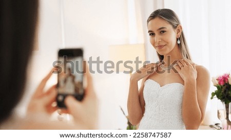 Wedding, ring and engagement with a woman or bride taking a photograph on a phone and drinking champagne with a friend. Happy, smile and celebration with an attractive young female and her bridesmaid