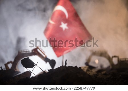Turkey Earthquake happend in February 2023. Decorative photo with Turkish flag, and ruined city buildings. Pray for Turkey. Selective focus Royalty-Free Stock Photo #2258749779