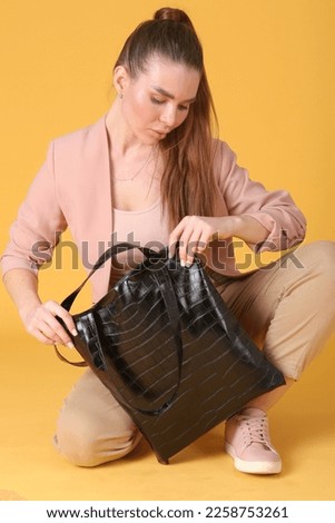 faux leather black shopper bag close up photo with model hands. High quality photo