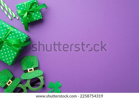 Saint Patrick's Day concept. Top view photo of green gift boxes with ribbon bows hat shaped party glasses straws and clover on isolated violet background with copyspace