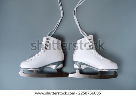 Pair of white figure ice skates shoes on blank gray background