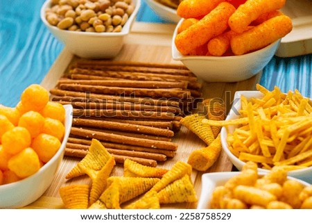 Party food. Salty snacks served as party food in bowls