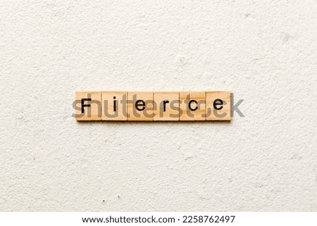 Fierce word written on wood block. Fierce text on cement table for your desing, Top view concept.
