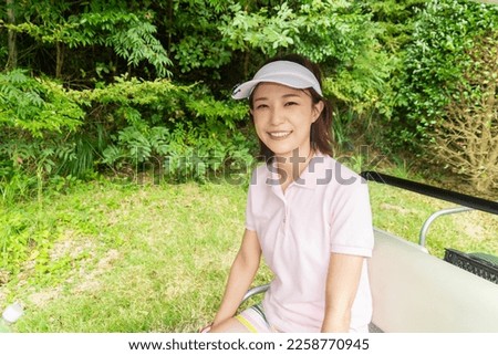Beautiful young asian woman play golf 