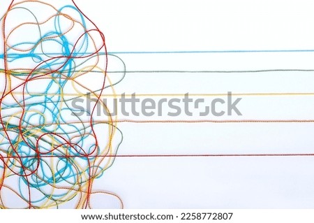 Multicolored tangled knitting threads on a white background Royalty-Free Stock Photo #2258772807