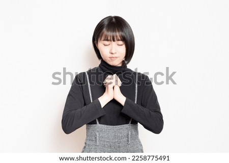 Young woman asking for a favor Royalty-Free Stock Photo #2258775491