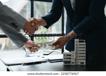 Real estate agent receive money from his client. Successful purchase agreement