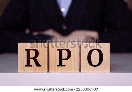 The word "RPO" written on wood cube. Recruitment process outsourcing