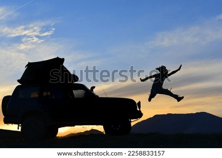 camping trip with vehicle and dynamic camper, mountaineer and adventurous man