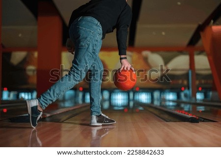 Concentration and focus on display as players aim for that perfect strike. Bowling brings excitement to any leisure night, rolling balls and falling pins fills the air as players in a game of bowling