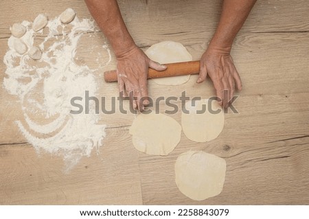 Rolling out the dough with your hands. Cooking food