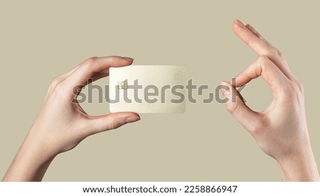 Bank credit debit plastic card mockup in hand and OK gesture sign with fingers. Blank bankcard with chip. High quality photo