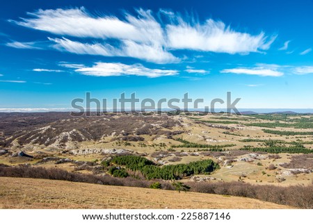 Beautiful deep blue sky with cirrus clouds over steppe landscape in Crimea peninsula, Russia - nature background