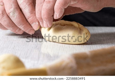 Human hands make pies. The concept of making homemade, tasty and healthy pastries.