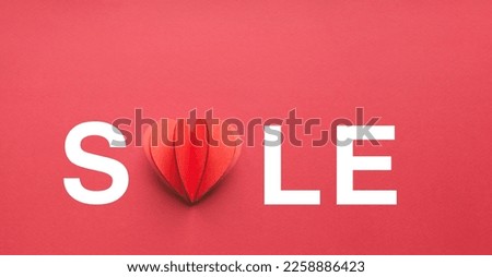 Sale banner for valentine's day. Handmade paper heart on red background. 