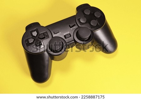 Wireless joystick gamepad controller on yellow background