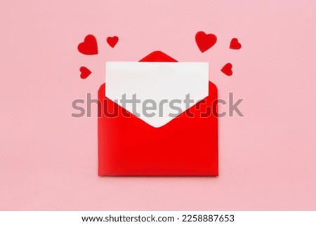 Red paper envelope with blank white note mockup inside and Valentines hearts on pink background. Flat lay, top view. Romantic love letter for Valentine's day concept Royalty-Free Stock Photo #2258887653