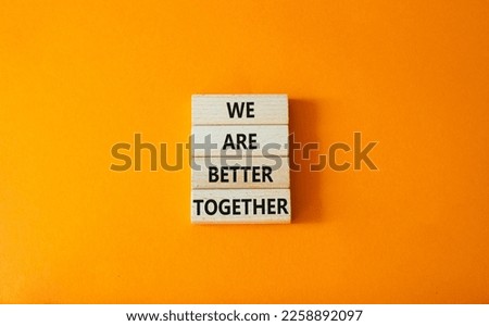 We are stronger better symbol. Wooden blocks with words We are better together. Beautiful orange background. We are stronger better concept. Copy space.