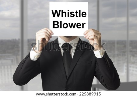 businessman in black suit hiding face behind sign whistle blower