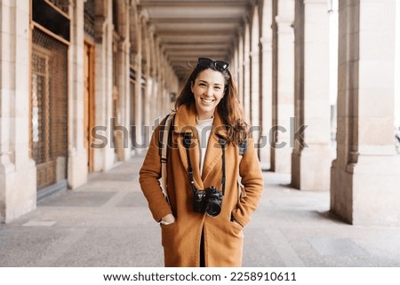 Young tourist woman photographer visiting European city in winter - Passion for photography