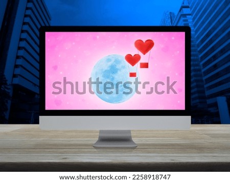 Red fabric heart love air balloon fly over moon and pink star on computer screen on wooden table over city, Internet dating online, Valentines day concept, Elements of this image furnished by NASA
