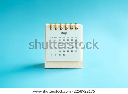 May 2023 calendar desk for the organizer to plan and reminder isolated on light blue background, minimal style. Small table calendar with the page of the fifth month.
