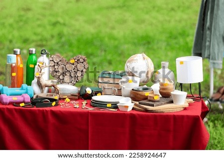 Different items on table outdoors. Garage sale Royalty-Free Stock Photo #2258924647