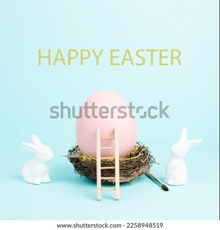 Easter bunny or rabbit sitting next to a huge pink colored egg in a birds nest, paint brush and ladder, spring holiday 
