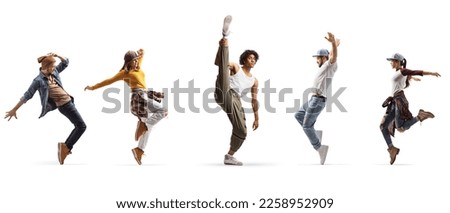 Group of young male and female dancers performing street dance isolated on white background