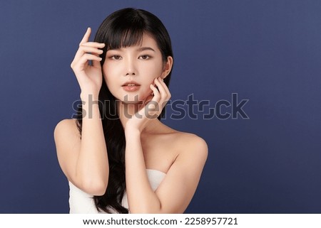 Beautiful young asian woman with clean fresh skin on Blue background, Face care, Facial treatment, Cosmetology, beauty and spa, Asian women portrait.