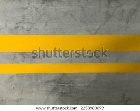 Cement wall texture with yellow paint strips