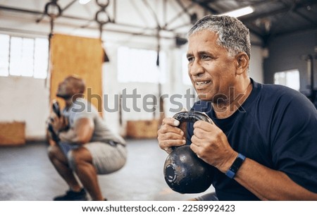 Training, senior and man exercise with personal trainer at the gym squat with kettlebell equipment for strength. Elderly, old and fitness people workout in a health club for wellness and motivation Royalty-Free Stock Photo #2258992423