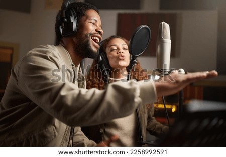 Music, man and woman recording in studio in home, singing into microphone with headphones and talent. Technology, art and creative influencer band or musician with live stream song for record label.