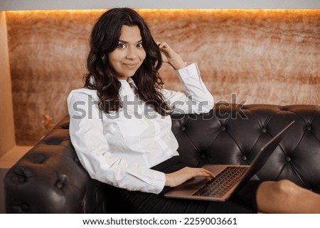 Beautiful slim elegant young indian or arabian business woman working remotely from home using laptop