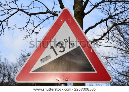 13% steep road warning sign