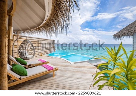 Fantastic over water villa, terrace view with sun beds chairs under umbrella, luxury pool hotel with stunning ocean view. Beautiful spa or wellness concept, recreational vacation resort tranquil area
 Royalty-Free Stock Photo #2259009621