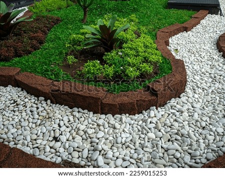 Modern front yard with beautiful garden and white stone garden Royalty-Free Stock Photo #2259015253