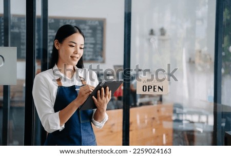 Startup successful small business owner sme woman stand with tablet  in cafe restaurant. woman barista cafe owner. 